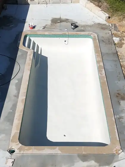 Nerang: limestone coping, green waterline tiles, white glass crete