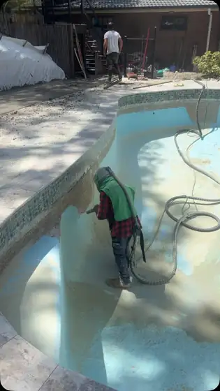 Sandblasting epoxy paint off a pool